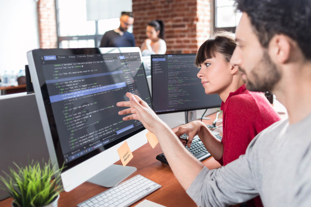 coworkers working on programming