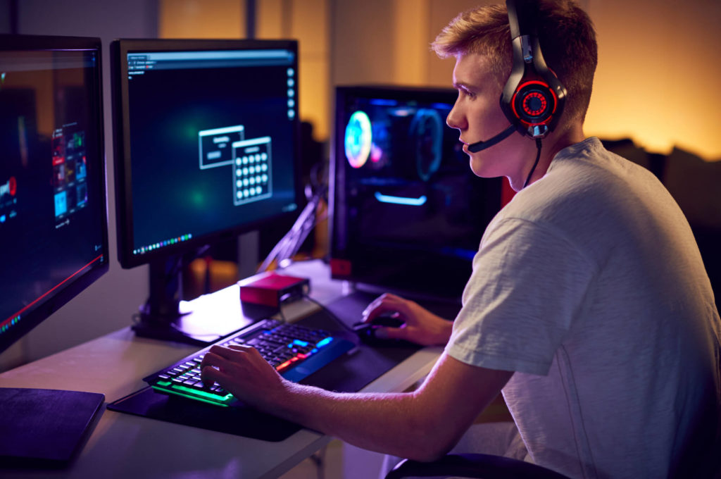 young man playing video game with headset