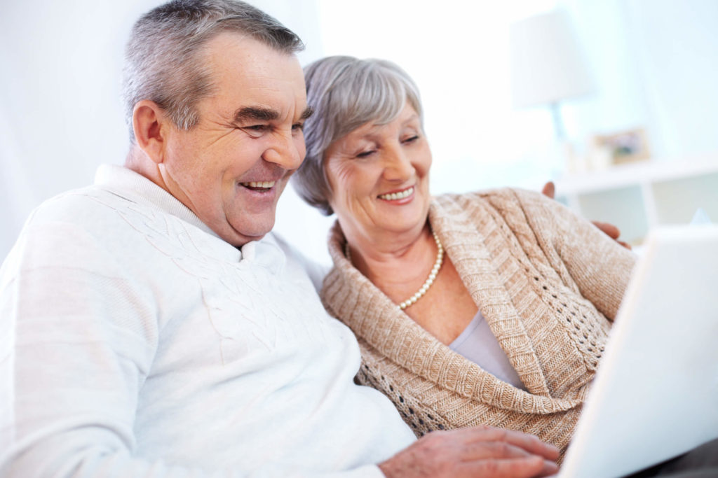 grandparents working on laptop