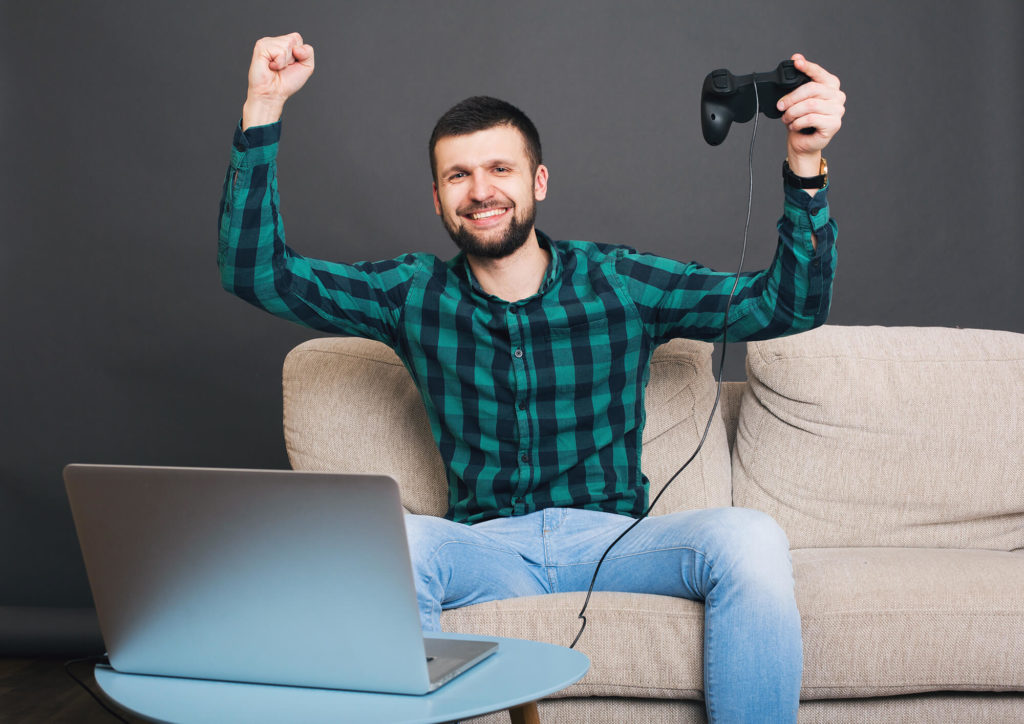 man playing video games on laptop