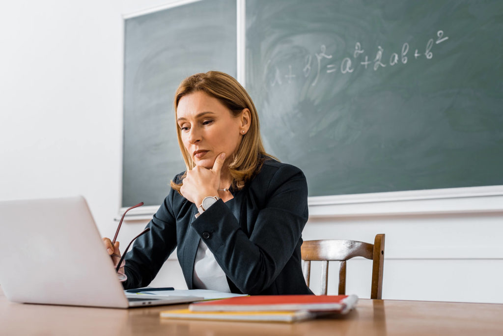 teacher working on laptop