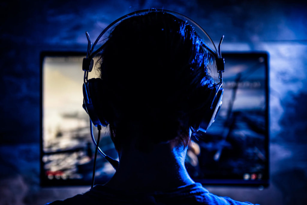 man sitting in front of gaming screen