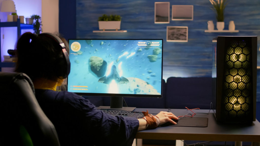 boy playing space game on laptop