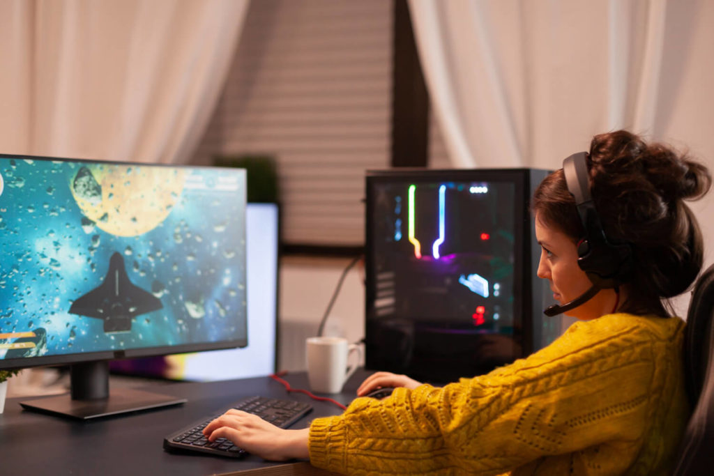 professional female gamer playing space game on computer